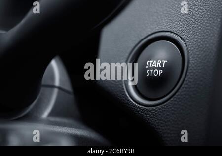 Start engine button. Start stop engine button on a modern car dashboard. Car engine start and stop button. Stock Photo