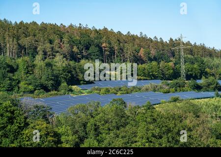 Solar installation, solar power plant, in a wooded area in Sauerland, Wennemen, NRW, Germany Stock Photo