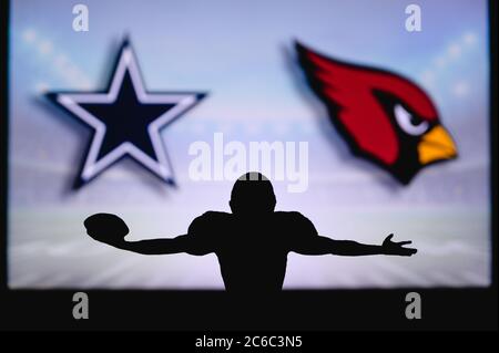 Dallas Cowboys vs. Arizona Cardinals . NFL Game. American Football League match. Silhouette of professional player celebrate touch down. Screen in bac Stock Photo