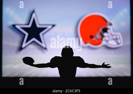 Dallas Cowboys vs. Cleveland Browns. NFL Game. American Football League match. Silhouette of professional player celebrate touch down. Screen in backg Stock Photo