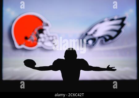 Cleveland Browns vs. Philadelphia Eagles. NFL Game. American Football League match. Silhouette of professional player celebrate touch down. Screen in Stock Photo