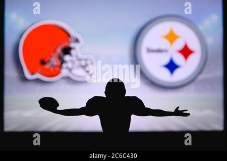 Cleveland Browns vs. Pittsburgh Steelers. NFL Game. American Football League match. Silhouette of professional player celebrate touch down. Screen in Stock Photo