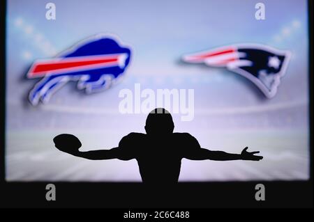 Buffalo Bills vs. New England Patriots. NFL Game. American Football League match. Silhouette of professional player celebrate touch down. Screen in ba Stock Photo