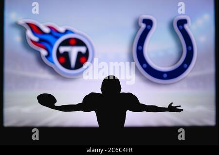 Tennessee Titans vs. Indianapolis Colts. Fans support on NFL Game.  Silhouette of supporters, big screen with two rivals in background. Stock  Photo