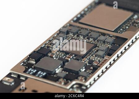 Close-up of a circuit board from the modern mobile tablet phone with CPU RAM chips and other electronic component. Stock Photo