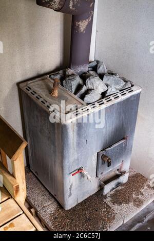 Old wood burning sauna heater stove with water heater in Orivesi, Finland Stock Photo