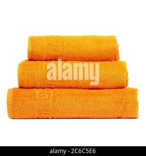 3 frotte towels orange color, bedroom towel white backgroung. Colorful orange bath towels isolated on white. Stack orange towels. Pile colored towels Stock Photo