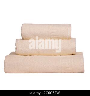 3 frotte towels beige color, bedroom towel white backgroung. Colorful beige bath towels isolated on white. Stack beige towels. Pile colored towels Stock Photo