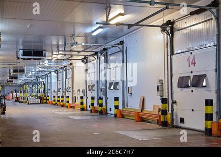 St. Petersburg, Russia - October 10, 2016: The area of loading and unloading docks in a cold grocery warehouse. Perishable food storage, truck gates. Stock Photo