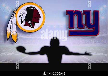 Washington Redskins vs. New York Giants. NFL Game. American Football League match. Silhouette of professional player with open arms, who holds ball in Stock Photo