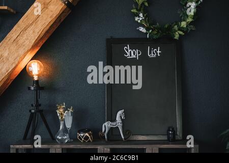 Black empty board in the kitchen for shopping list. Mock-up. Stock Photo