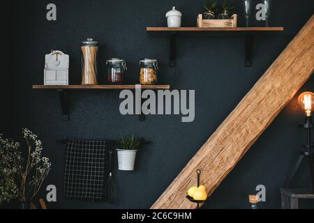 Pasta and grocery in glass jars on a wooden shelf in the kitchen. Detail Stock Photo