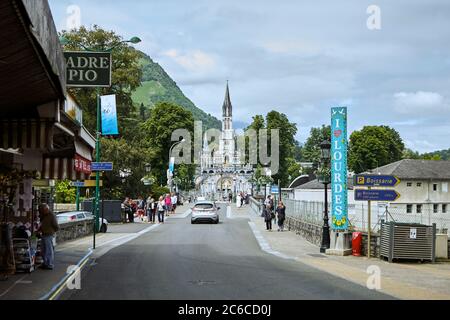 Lourdes, France - June 18, 2018: The road leading to the holy place. The Sanctuary of Our Lady of Lourdes or the Domain. Stock Photo