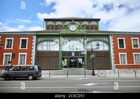 Lourdes, France - June 18, 2018: The facade of the covered market with a clock above the entrance Stock Photo