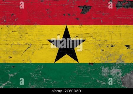 Ghana flag on grunge scratched concrete surface. National vintage background. Retro wall concept. Stock Photo