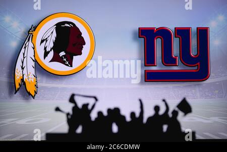 Washington Redskins vs. New York Giants. Fans support on NFL Game. Silhouette of supporters, big screen with two rivals in background. Stock Photo