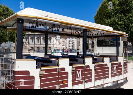 MONTPELLIER, FRANCE - June 24, 2015: La Promenade du Peyrou. People and empty carriage of sightseeing bus (Le Petit Train De Montpellier) Stock Photo
