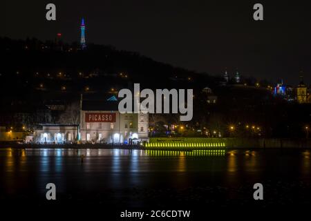 Nighttime view across Vltava River towards Museum Kampa and Petrin Lookout Tower, Prague, Czech Republic