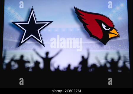 Dallas Cowboys vs. Arizona Cardinals . Fans support on NFL Game. Silhouette of supporters, big screen with two rivals in background. Stock Photo