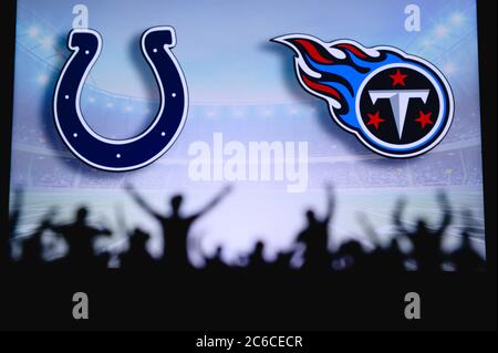 Indianapolis Colts vs. Tennessee Titans. Fans support on NFL Game. Silhouette of supporters, big screen with two rivals in background. Stock Photo