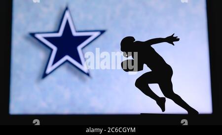 Dallas Cowboys professional american football club, silhouette of NFL  trophy, logo of the club in background Stock Photo - Alamy