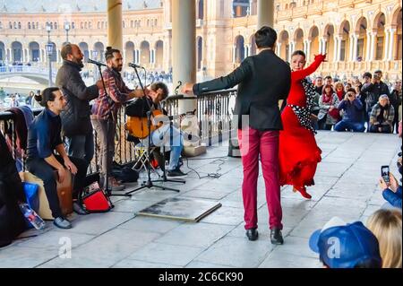 Seville, Spain – January 2, 2020: A group of street entertainers performs flamenco dancing at Plaza de Espana. Stock Photo