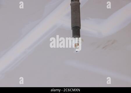 Technician install automatic fire sprinkler on the ceiling in office building Stock Photo