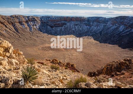 A Winter view of the Barringer Meteor Crater with snow in the shadows. Along Interstate 40 near Winslow, Arizona. Stock Photo