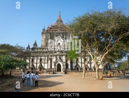 A group of tourists gaze at the exterior of the Thatbyinnyu temple in Bagan, Myanmar Stock Photo