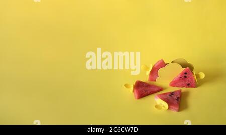 Watermelon slices on an ice cream stick on an yelloow background. Creative idea Stock Photo