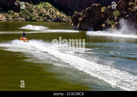 Jet ski enthusiasts enjoy a Summer day on Canyon Lake along the Salt River in central Arizona. Stock Photo