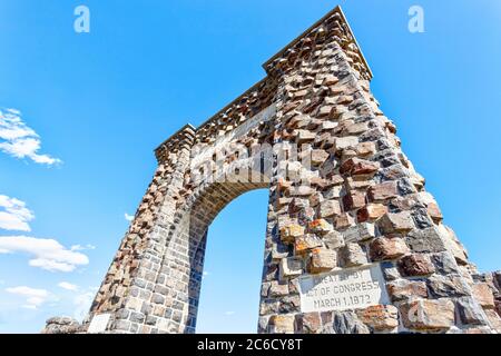 Low angle view of the historic Roosevelt Arch at the north entrance of Yellowstone National Park in Gardiner, Montana. Stock Photo