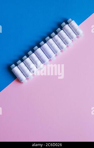 Row Of WhiteThread Spools On Table flatlay Stock Photo