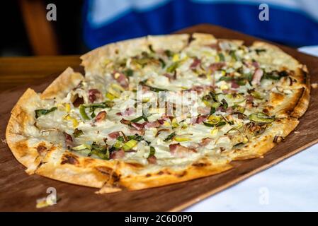 Tarte Flambee, ATraditional French Dish. Fresh Baked In A Wood-Fired Traditional Adobe Oven. Flame Cake - English, Flammkuchen - German Stock Photo