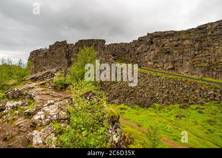 View of the path in the Thingvellir National Park, rift valley that marks the crest of the Mid-Atlantic Ridge and the boundary between the North Ameri Stock Photo