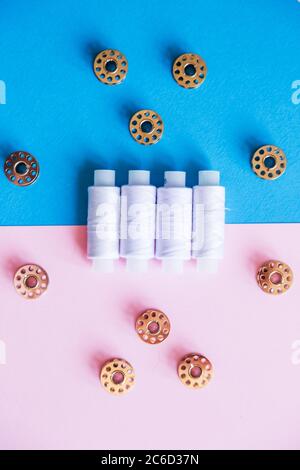 Row Of WhiteThread Spools and Small Bobbins Of Thread Used In A Sewing Machine  Stock Photo