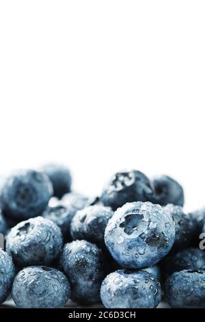 Tasty blueberries fruit are scattered on a white background. Stock Photo