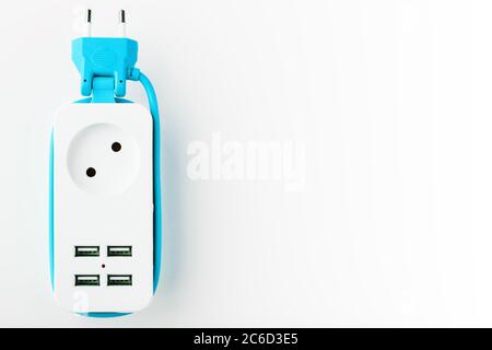 Extension Socket with USB Port on white background for charging phones and electronic devices, blue power cord. Stock Photo