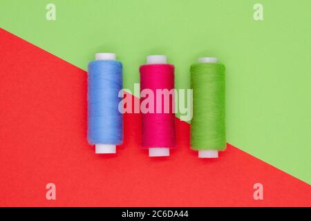 Top view of multi-colored sewing reels on a colored background. Hobby concept Stock Photo