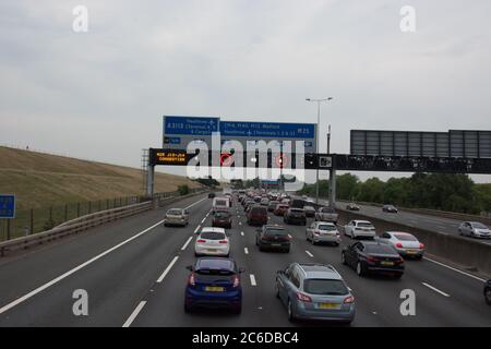 Slow moving traffic on the M25 Motorway as it heads to Junction 14 with 40 MPH variable speed limit in place. Stock Photo