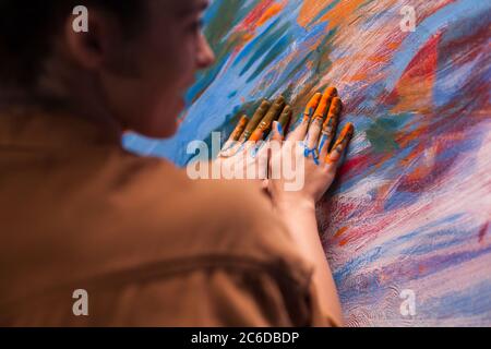Hands of artist with paint on canvas in art studio. Modern artwork paint on canvas, creative, contemporary and successful fine art artist drawing masterpiece Stock Photo