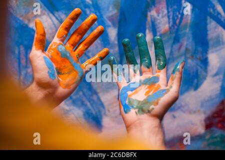 Artist painted hands in art workshop. Modern artwork paint on canvas, creative, contemporary and successful fine art artist drawing masterpiece Stock Photo