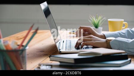 Close up Woman working at home office hand on laptop keyboard Stock Photo