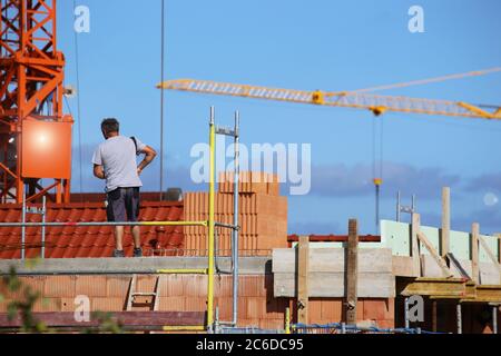 Construction worker (bricklayer) works on the construction site Stock Photo