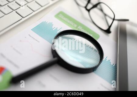 Magnifier glasses lie on table with documents in office Stock Photo