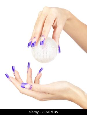 Hands with blue french false acrylic nails manicure holding christmas ball isolated on white background Stock Photo