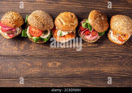 Assorted sandwiches on wooden table Stock Photo