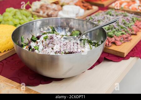 Salad bowl, salad with sprouted seeds and beets. View from above. Selective focus. In the background snacks on a wooden tray. Stock Photo