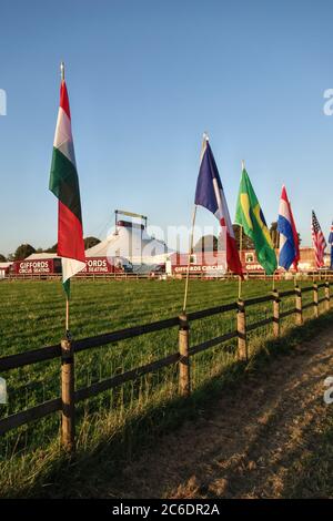 Flags of all nations line the approach to Giffords Circus at their headquarters at Fennells Farm, Stroud, Gloucestershire, UK Stock Photo