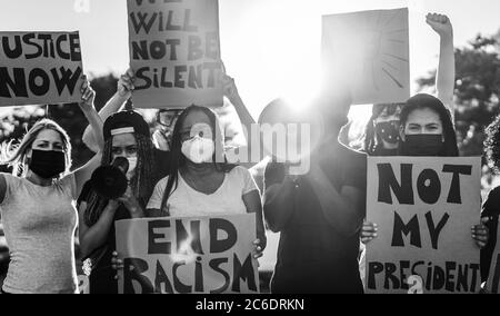 People from different ages and races protest on the street for equal rights - Demonstrators wearing face masks during black lives matter fight campaig Stock Photo